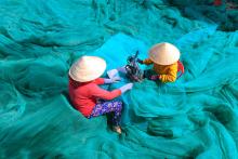 Sector-Specific Materials: Women sewing casting nets wider